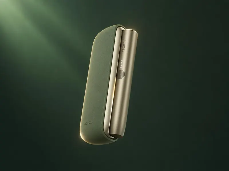 IQOS ILUMA heated tobacco device on an emerald surface